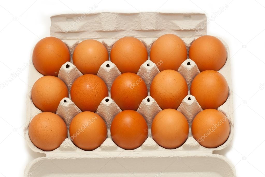 Brown chicken eggs in a carton. 15 eggs. top view