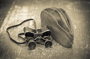 Victory Day on May 9. Vintage military binoculars and a field cap