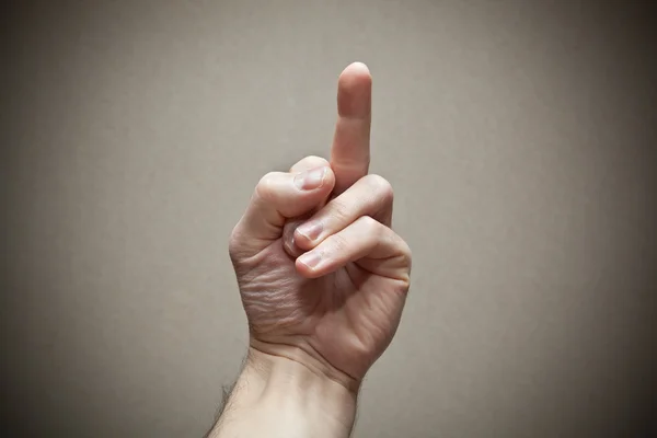 Middelste vinger als een teken van agressie - fuck off. — Stockfoto