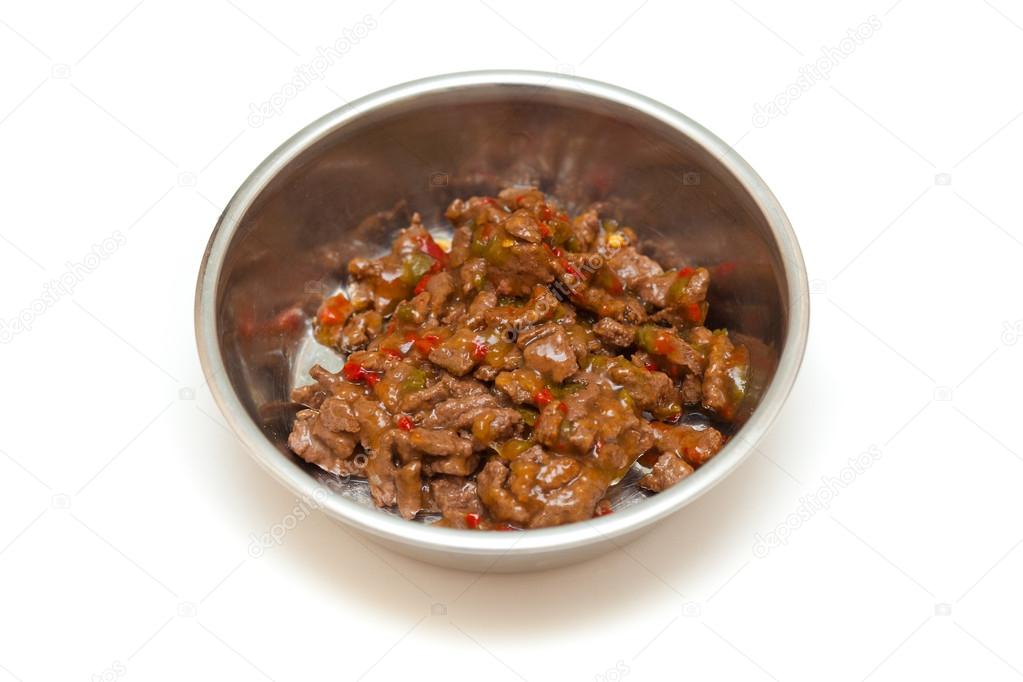 Bowl with meat and vegetables for the animals isolated on a white background. Food for dogs and cats