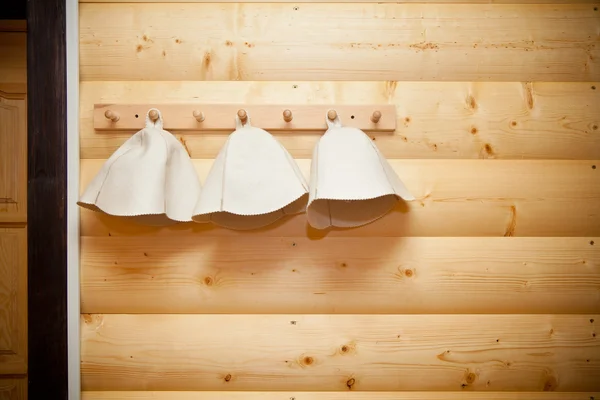 Hats for sauna and bath hanging on the hanger — Stock Photo, Image