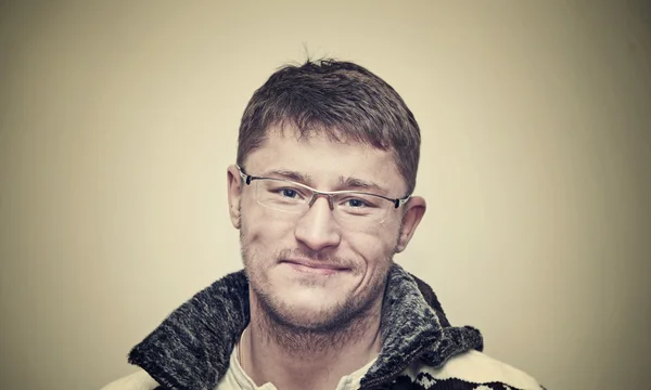 Unshaven positive man smiling at the camera, studio shot — Stock Photo, Image