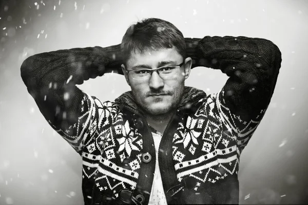 Young man in a winter sweater, falling snow flakes — Stock Photo, Image