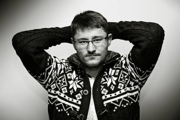 Unshaven man with glasses in a fashionable sweater — Stock Photo, Image