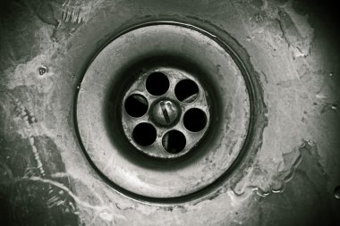 Drain hole in the kitchen sink close-up clipart
