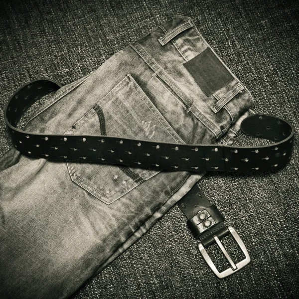 Details of clothes: fashion jeans, a leather belt with a buckle — Stock Photo, Image