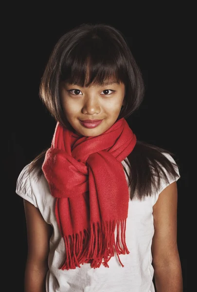 Beautiful Tanned Asian girl in a red scarf — Stock Photo, Image