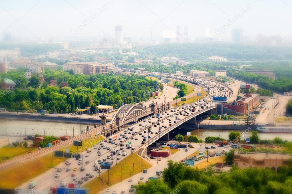 Panorama of Moscow in the haze, Russia. Third Ring Road with cars, Moscow river.