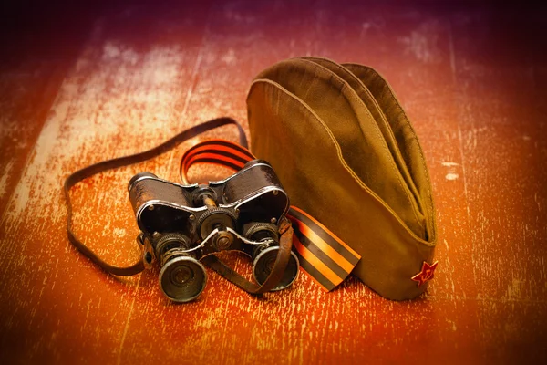 Old binoculars, George Ribbon and soldier field cap with the star. 70 years anniversary of victory on May 9 — Stock Photo, Image