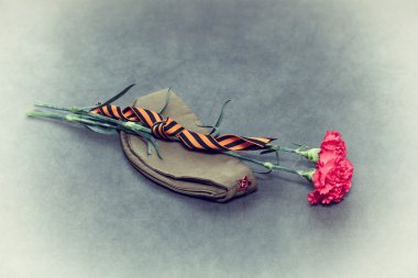 Carnation, George Ribbon and field cap. Vintage Photo. In honor of the victory in World War II clipart