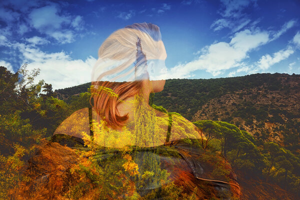 Girl with her hair back. a beautiful landscape of mountains, trees and the sky with clouds. The effect of double exposure, photo collage.