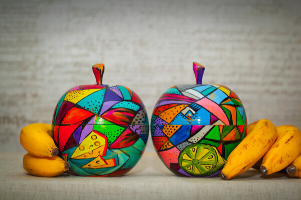 Modern art artist - fantastic bright multicolored apples and bananas. Fantastic decorative fruit. Hand piece-work - is painted by hand paints