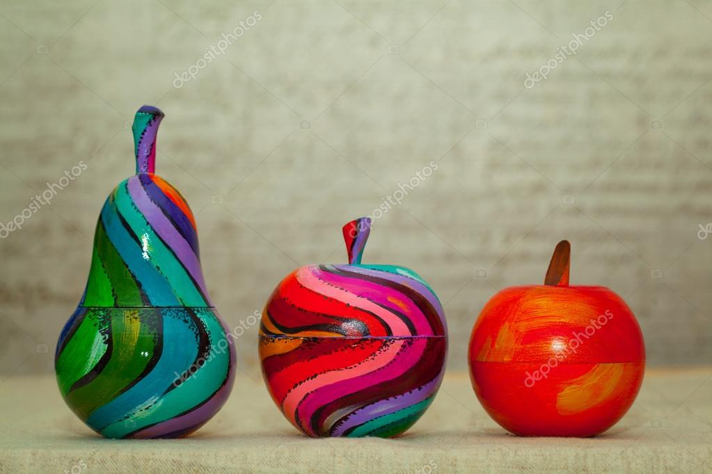 Wooden colorful pears and apples. Decorative fruit painted by hand