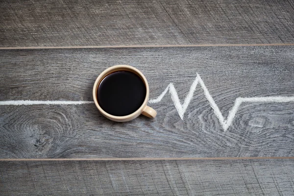 Cup of black coffee and symbolic cardiogram — Stock Photo, Image