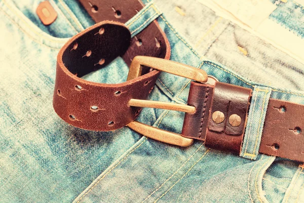 Vintage jeans with brown leather belt. Photos in retro style — Stock Photo, Image