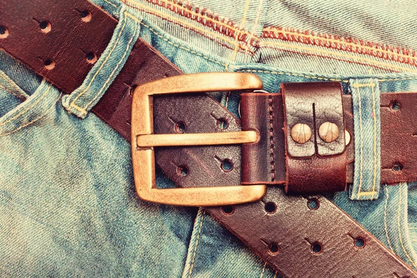 Detail of nice blue jeans with leather belt in vintage style — Stock Photo, Image