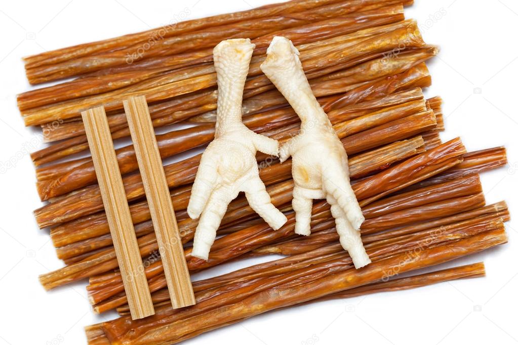 Tasty treats for dogs - dried beef, chicken feet and sticks for chewing and toothbrushing