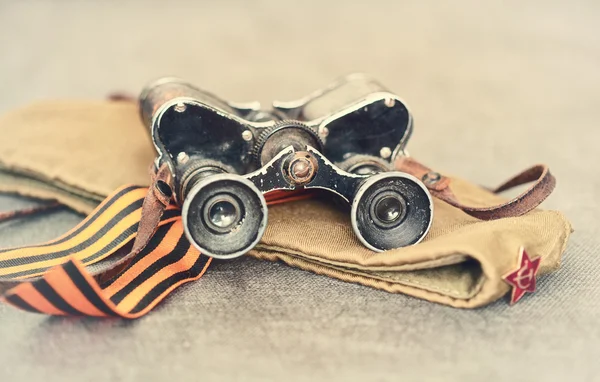 Vintage military still life military binoculars, cap, St. George ribbon — Stock Photo, Image