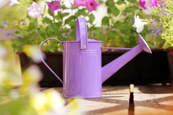 Watering flowers in balcony with watering can — Stock Photo, Image