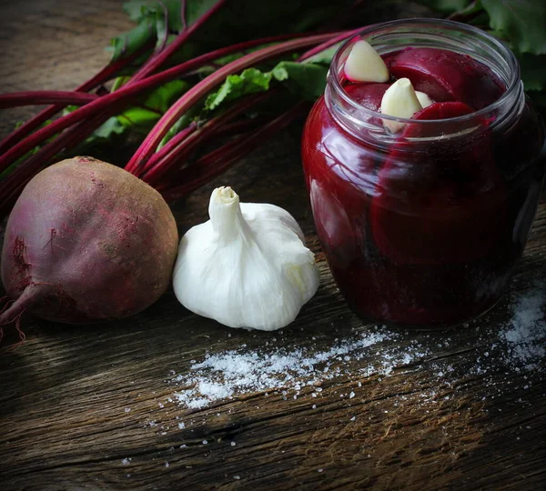 Pickled beets in the jar on a dark wood background — Stock Image Pickled beets in the jar on a dark wood background Stock Photo