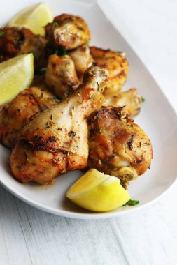 Kızarmış tavuk budu. Bacakları beyaz tabakta.