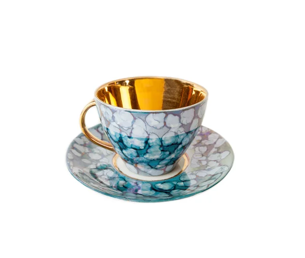 Vintage teacup and saucer in blue and gold isolated over white — Stock Photo, Image