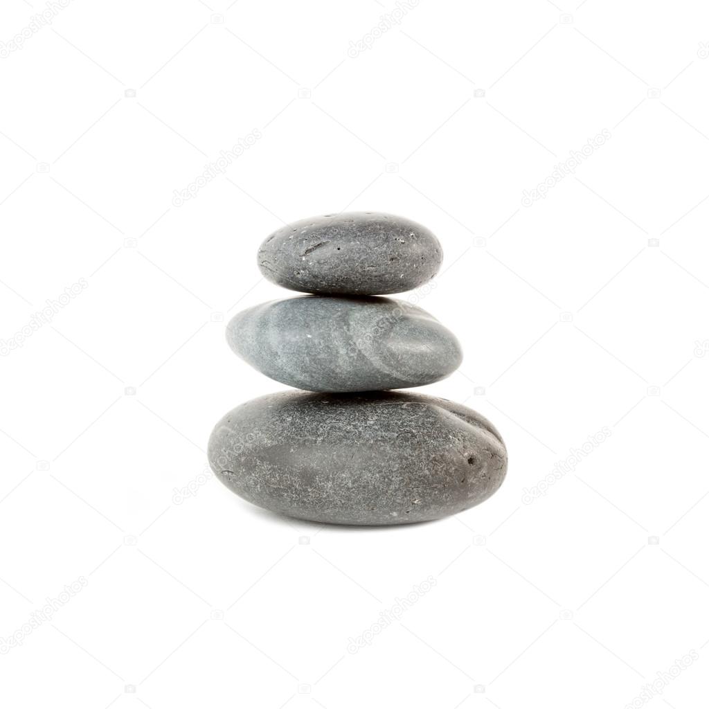 Three smooth stones on each other isolated over white background
