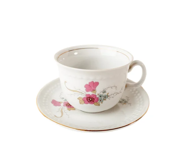 Taza de té y platillo de porcelana con motivos florales aislados sobre blanco — Foto de Stock