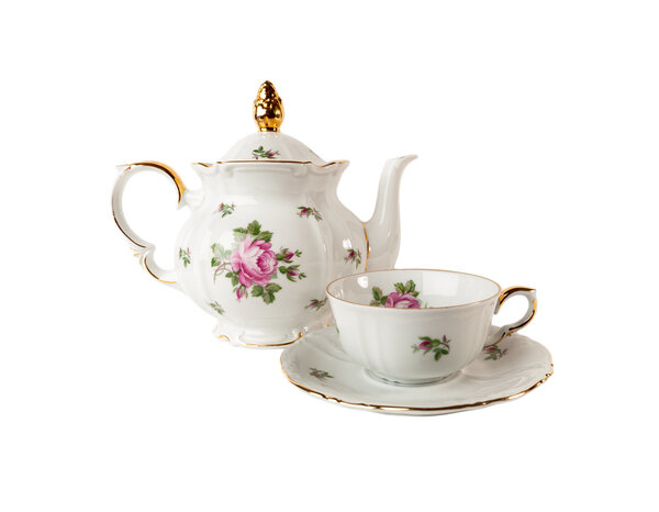 Porcelain teapot, teacup and saucer with floral rose ornament in classic style isolated over white