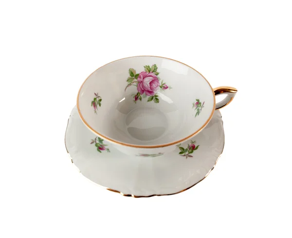 Porcelain teacup and saucer with floral rose ornament isolated over white Royalty Free Stock Images