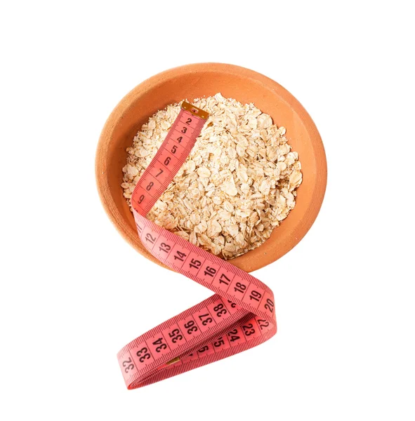 Oatmeal and Measuring tape as Healthy lifestyle concept — Stock Photo, Image