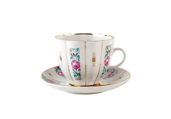 Porcelain teacup and saucer with floral roses ornament in retro isolated over white — Stock Photo, Image