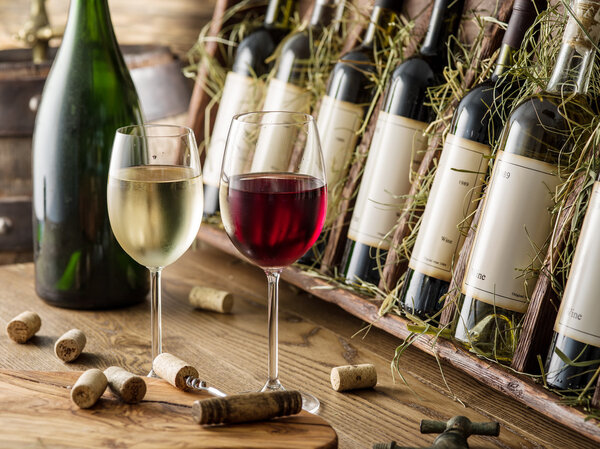 Wine bottles on the wooden shelf.