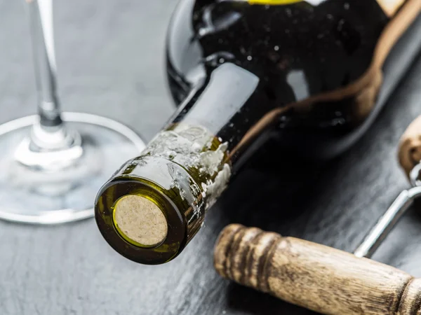 Wine bottle, wine glass and corkscrew on the graphite board. — Stock Photo, Image
