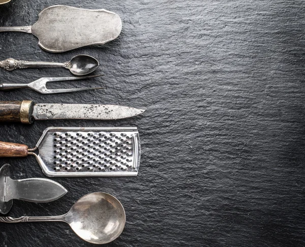 Kitchen utensils on the graphite background. — Stock Photo, Image