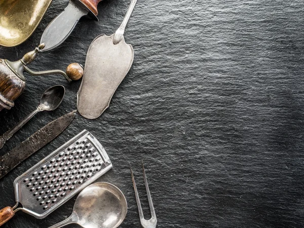 Kitchen utensils on the graphite background. — Stock Photo, Image