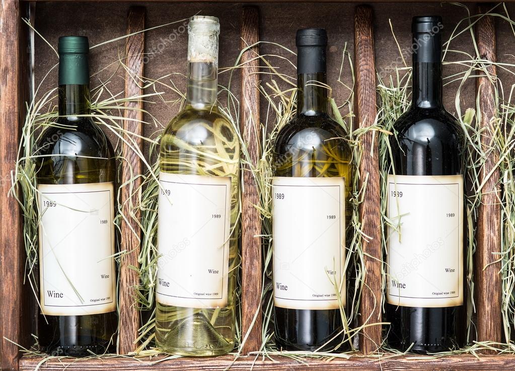 Wine bottles on the wooden shelf.