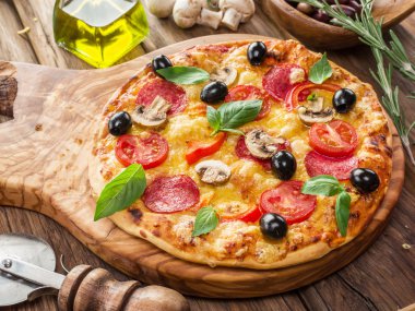 Mantar, salam ve domates pizza.
