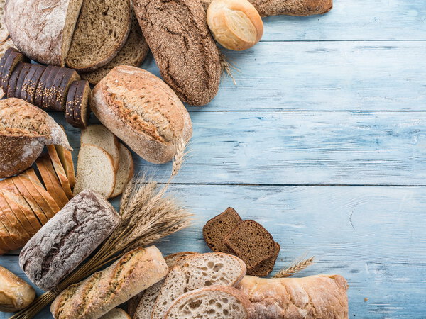 The bread and a wheat on the wooden desk.