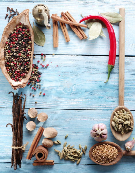 Different spices on old wooden table.