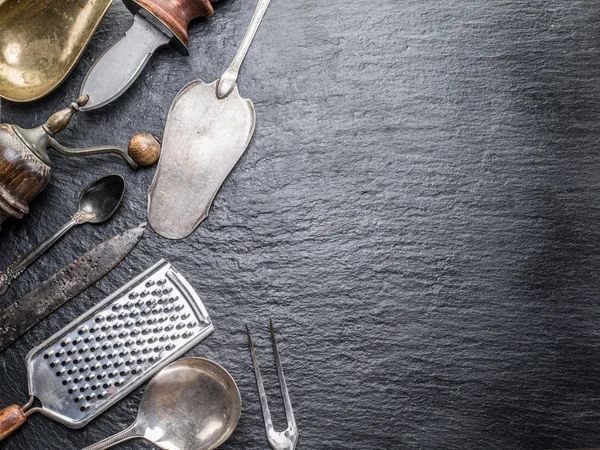 Kitchen utensils on the graphite background. — Stock Photo, Image