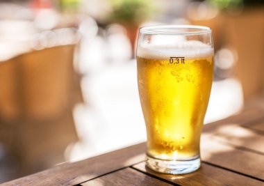 Ahşap masa üzerinde light bira bardak.