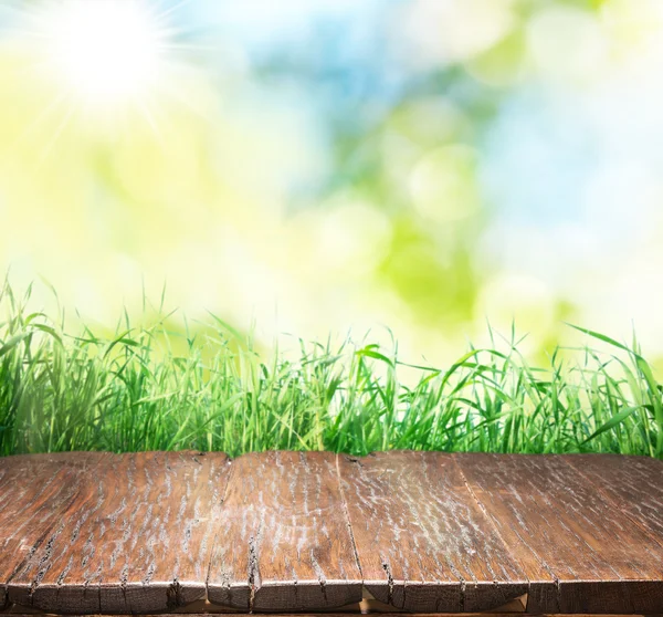 Alter brauner Holzboden mit grünem Gras am Rand. — Stockfoto