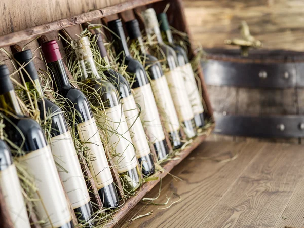 Wine bottles on the wooden shelf. — Stock Photo, Image