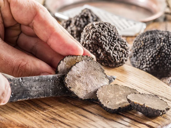 Trufas negras en la vieja mesa de madera. — Foto de Stock