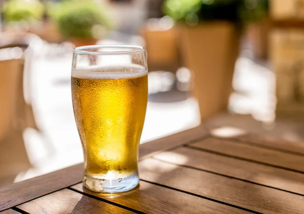 Glass of light beer on the wooden table. — Stock Photo, Image