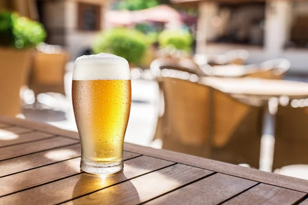 Glass of light beer on the wooden table. — Stock Photo, Image