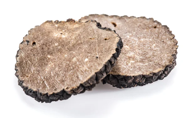 Slices of black summer truffle on a white background. — Stock Photo, Image