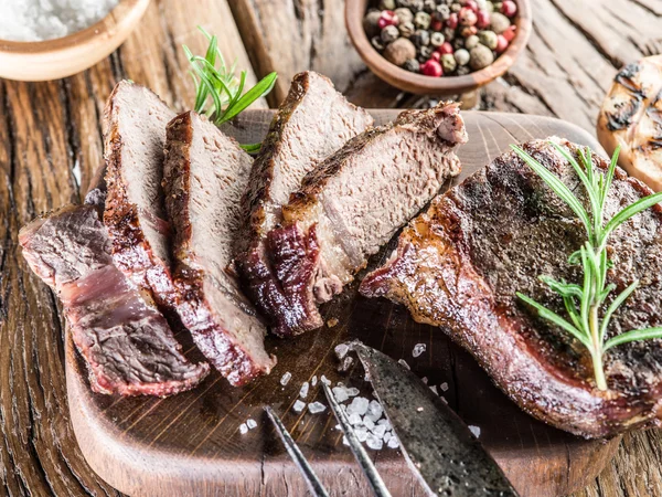 Ribeye steak s kořením na dřevěném podnosu. — Stock fotografie