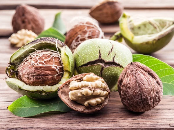 Walnut and walnut kernel on the wooden table. — Stock Photo, Image